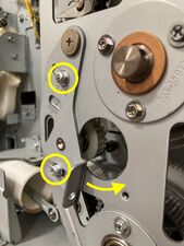 When these 2 screws are loosened, the tensioner will swing to the right, detensioning the main belt.