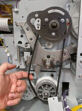 The slack in the belt is held to the left, while the right side of the belt is more taut.
