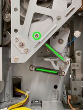 Remove both the silver timing spring (which is hooked to a peg behind the circled rivet) and black guide lever spring (note that in most machines the guide lever spring is attached to the middle peg).